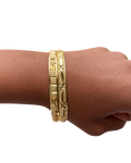 Two Stack Haus diamond-cut gold bangles worn together on wrist